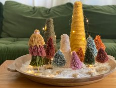 Display of Tassel and Wrapped Yarn Christmas Trees on Coffee Table