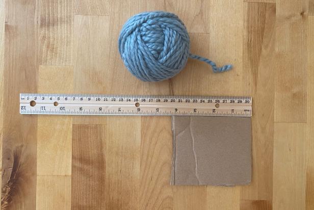 To make a pom-pom yarn tree, start by using a 4'' vertical piece of cardboard.