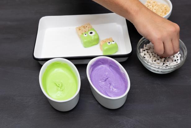 These white-chocolate-coated crispy rice treats have been turned into little rice monsters with purple and green-colored white chocolate and candy eyeballs. The DIY makes for a cute Halloween snack board idea.