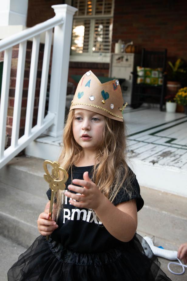 Little Girl in Queen Halloween Costume With Paper Bag Crown