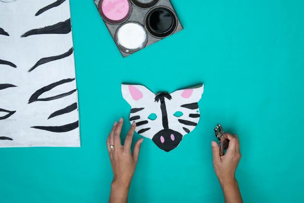 This DIY Halloween costume is made from a paper grocery bag and cut to look like a zebra. Black, white and pink paint help to sell the look.