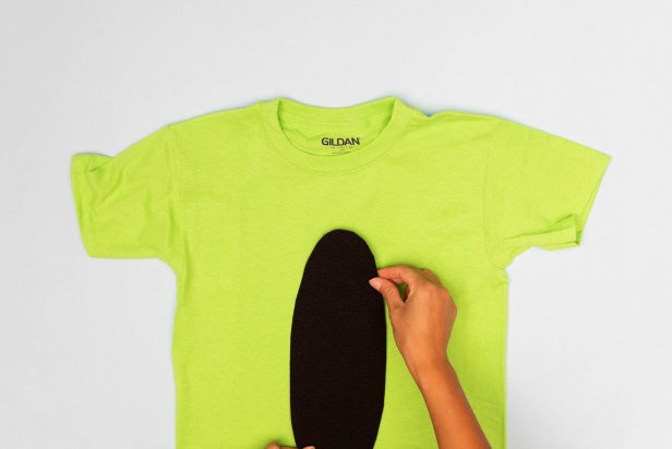 This green shirt is having a piece of black felt glued to it to turn it into a crayon Halloween costume.