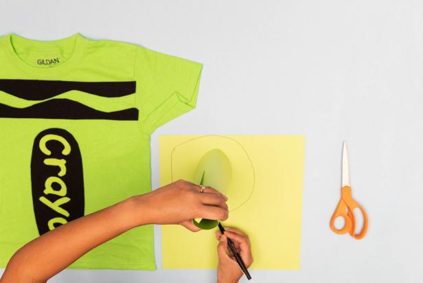 This DIY crayon Halloween costume utilizes a green t-shirt, black felt and a green card stock to turn a child into a walking crayon.