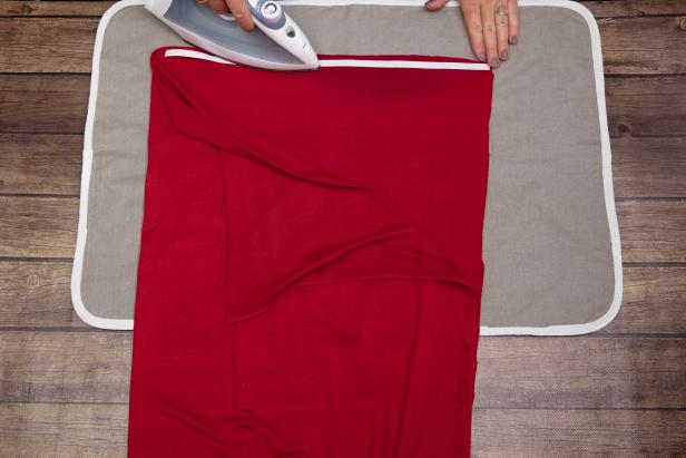 This red jersey fabric is attached to itself using no-sew iron-on hem tape to be worn as a Little Red Riding Hood Halloween costume.