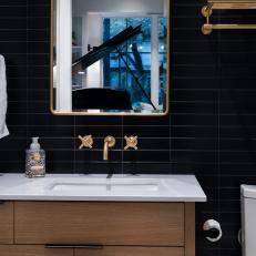 Black Small Bathroom With Brass Mirror