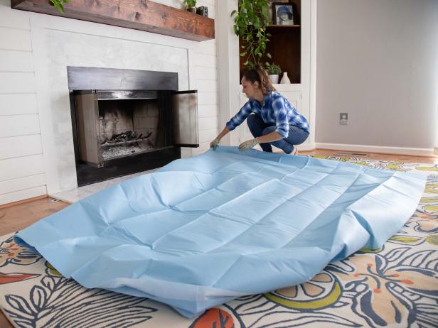 Place a large tarp on the floor in front of the fireplace.