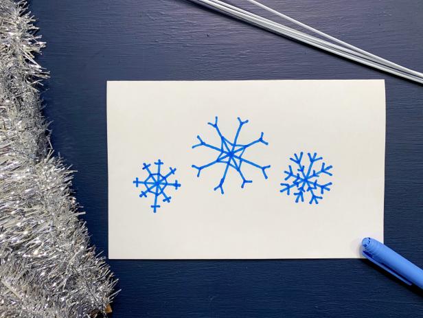 Search for snowflake images online and decide on which design to create. Measure the space where you would like to hang to determine the size.  TIP: Choose an image without a lot of detail or create your own snowflake pattern from scratch.