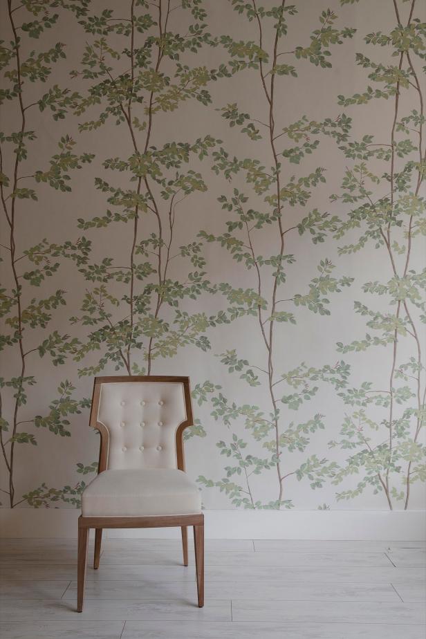 Room features white side chair and botanical wallpaper. 