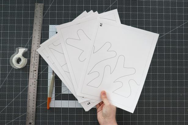 Print the Cardboard Tree Pattern onto cardstock. Cut off the smaller shapes from the first page and set them aside. Tape the pages together and cut out the tree.