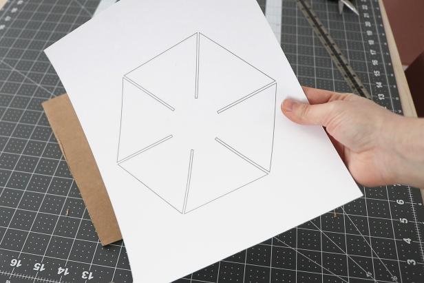 Cut out the base from the last page of the pattern. Trace and cut it out from cardboard. Cut a 1” x 2” rectangle from the bottom of your tree. Attach the base so each segment stays equally spaced apart.