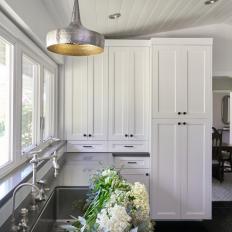 White Kitchen With Flowers in Sink