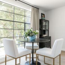 Contemporary Dining Area With White Chairs
