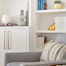 Gray Armchair and White Bookshelf