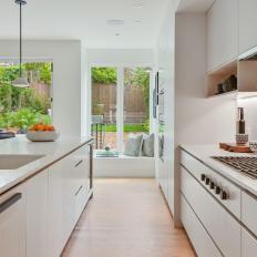 White Kitchen With Backyard View