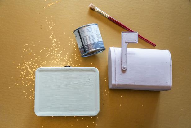 Paint the tin lunchbox and mailbox with white chalk paint.