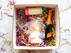 Box Filled With Champagne, Crinkle Paper, DIY Popper and Garland