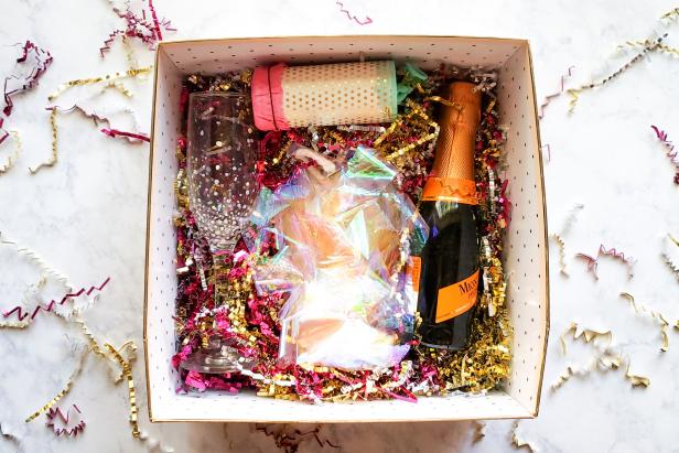 Box Filled With Champagne, Crinkle Paper, DIY Popper and Garland