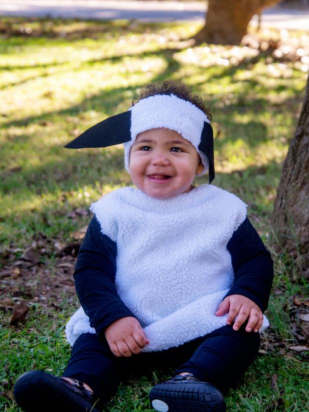 A baby in a lamb costume.