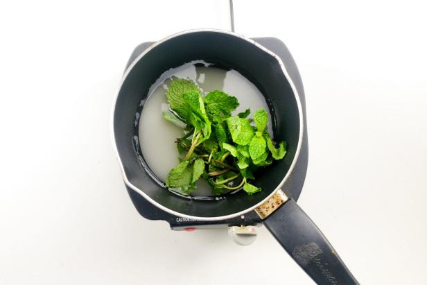 Simmering Saucepan of Mint Leaves, Sugar and Water