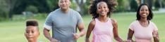 An African-American and Hispanic interracial family with two children having fun together, exercising in the park, jogging. The boy is 9 years old and his sister is 11.