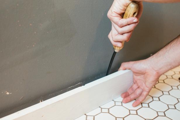 Use a prybar to remove baseboards