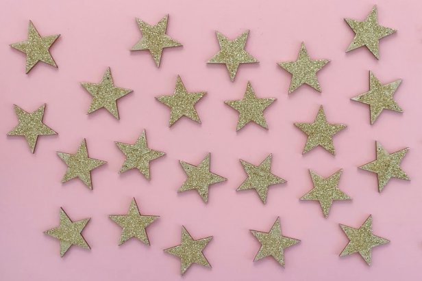 Let the batch of gold glitter stars dry for several hours before threading them through string to make the garland.