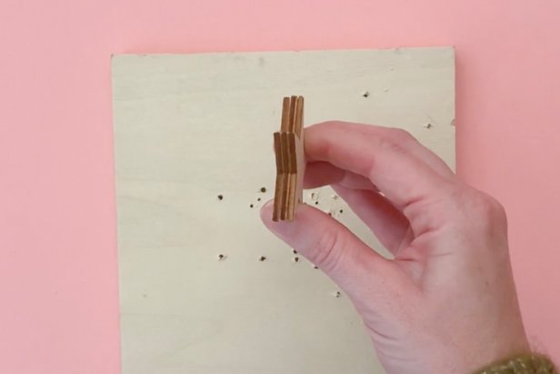 Drill holes in multiple wooden stars at once. Align a stack of two or three stars and use a drill to pierce a hole through all at the same time.