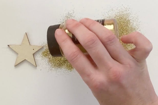 Shake on a thick layer of glitter to the decoupage glue on the wooden stars.