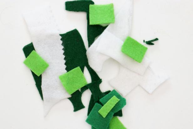 Gather all of your felt scraps, no matter how small. Cut fringe into the side and then cut across the fringe to get tiny squares of felt. Repeat this with all of the colors you want to use in each ornament and mix them together.