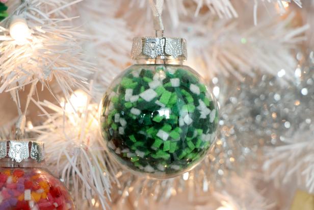 Green Confetti Ornament on White Christmas Tree 