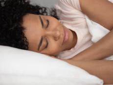 Young Woman Comfortable In Bed Sleeping Peacefully