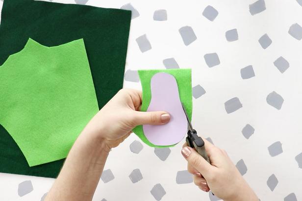 Draw an avocado shape on scrap paper and cut it out. Use your pattern to cut the same shape from light green and dark green felt.