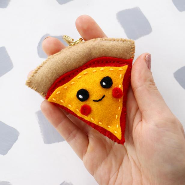 Create a pizza slice plushie key chain the same way as the avocado.