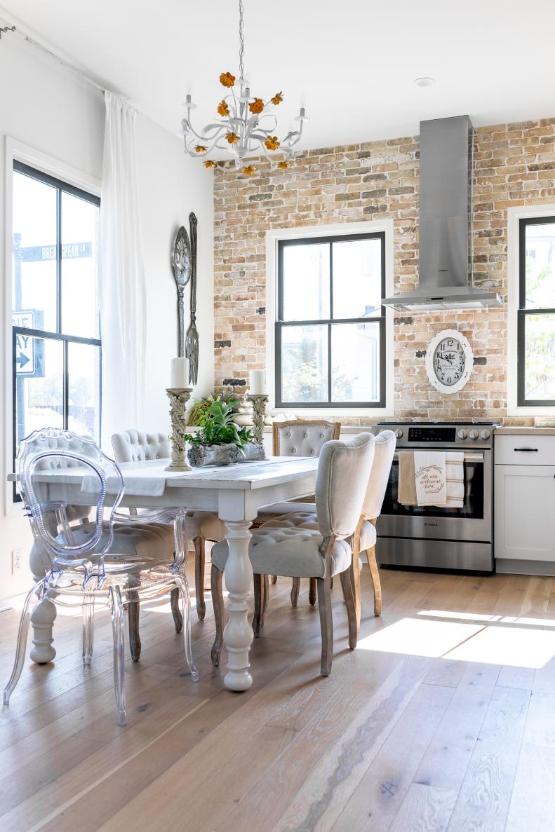 "I wanted a space where people could chat," says Tin of her home's ground floor design, with the kitchen on one side open to the living room on the other end. An open steel staircase in the middle of the space continues the airy feel. Tin found the chandelier in her kitchen in Paris.