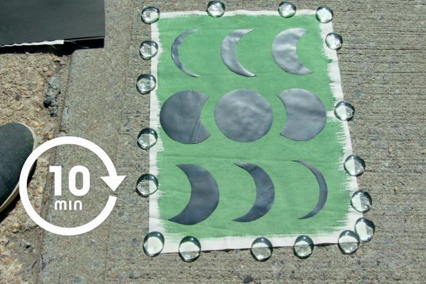 Cyanotype sun print of moon phases being exposed to sunlight