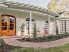 As seen on Home Town, the Combe residence has been fully renovated by Ben and Erin Napier. After renvations, their Laurel, MS home now features updated front doors, landscape, and columns. (After)