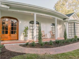 As seen on Home Town, the Combe residence has been fully renovated by Ben and Erin Napier. After renvations, their Laurel, MS home now features updated front doors, landscape, and columns. (After)