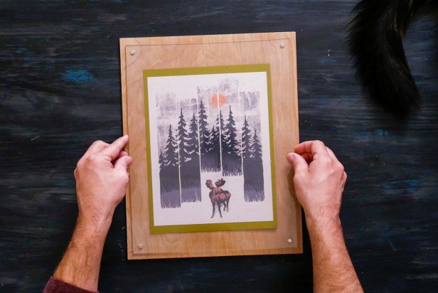Hands Holding Finished Magnetic Acrylic Frame With Photo of Trees