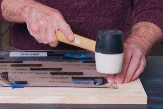 Using a rubber mallet, tap each magnet into the drilled holes. Magnets should be inserted into both acrylic and wood pieces.