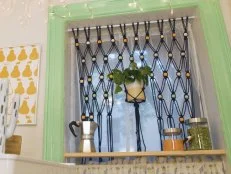 Beaded Boho Curtain Hangs in Window With Potted Plant in Middle