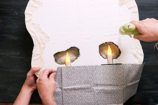 Use a low temp hot glue gun or tape fabric behind the eyes like curtains.