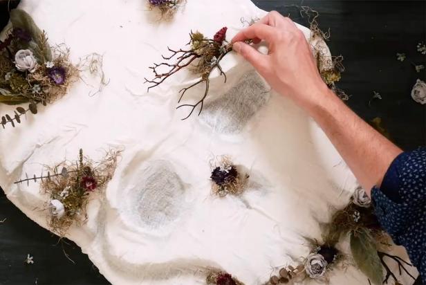 Hand Gluing Faux Florals and Branches Onto The Skull Face