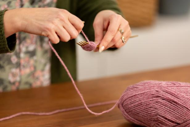 Take the loose end of yarn from the skein and begin wrapping it around the fork about 20 times. Wrap the yarn loosely, but tight enough to stay on the fork.