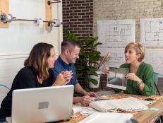 Erin Napier (R) shows designers Amanda Connolly (L) and Blake Erskin (C) the before photo of the future art studio space at the Luker House in Laurel, Mississippi. (action)