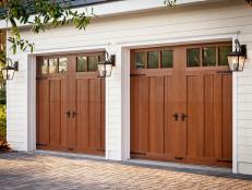 This garage door may look and feel like real wood, but it's made of moisture resistant materials so it won’t rot, warp, or crack. And, like real wood, the doors can be painted or stained. The cladding and overlays are molded from the species they emulate for realistic grain texture. The doors come in carriage house, modern, and louver designs.