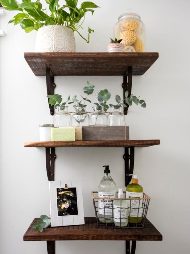 Floating shelves made from old barnwood provide stylish storage.