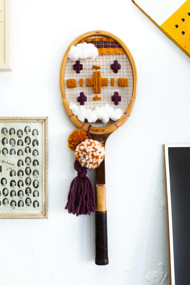 Tennis Racket Wrapped With Yard Hanging From Wall 