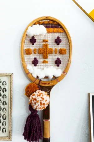 Offers vintage hand embroidered/needlepoint tennis racket cover