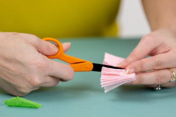 Using scissors, cut slits in the crepe paper to create smaller petals.