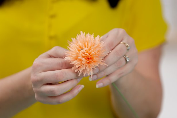 Using floral tape, wrap the base of the flower to the floral stem to secure.